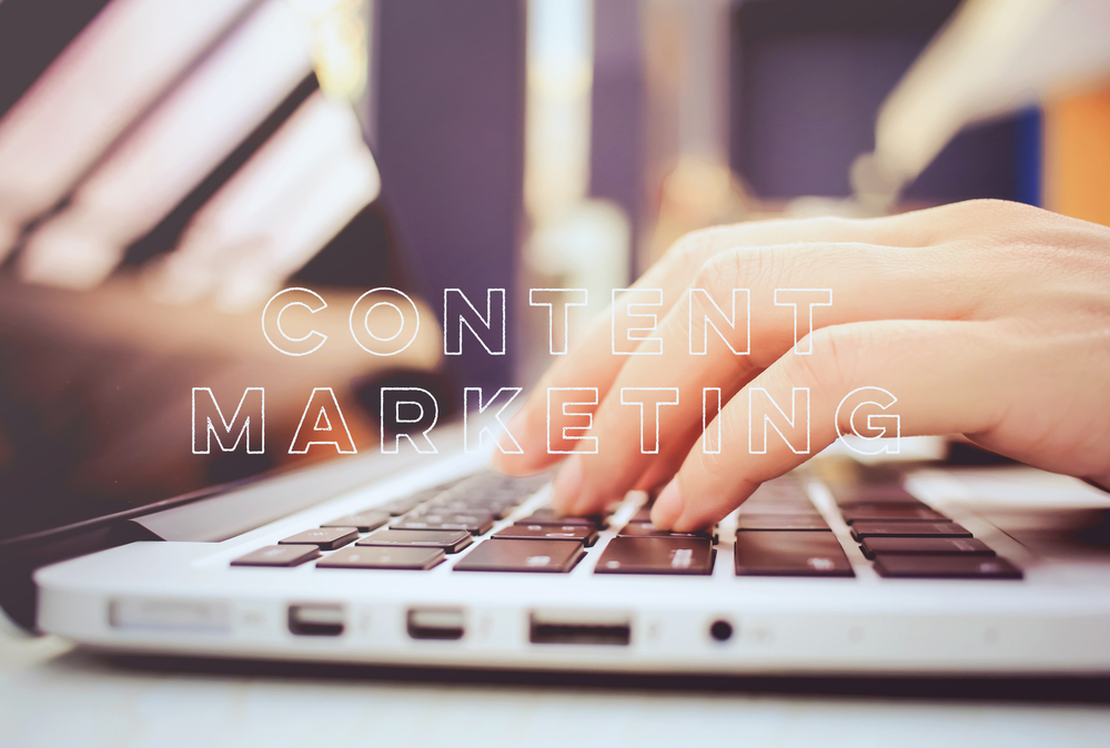 The title text "Content Marketing" overlaid over an image of a hand on a laptop keyboard