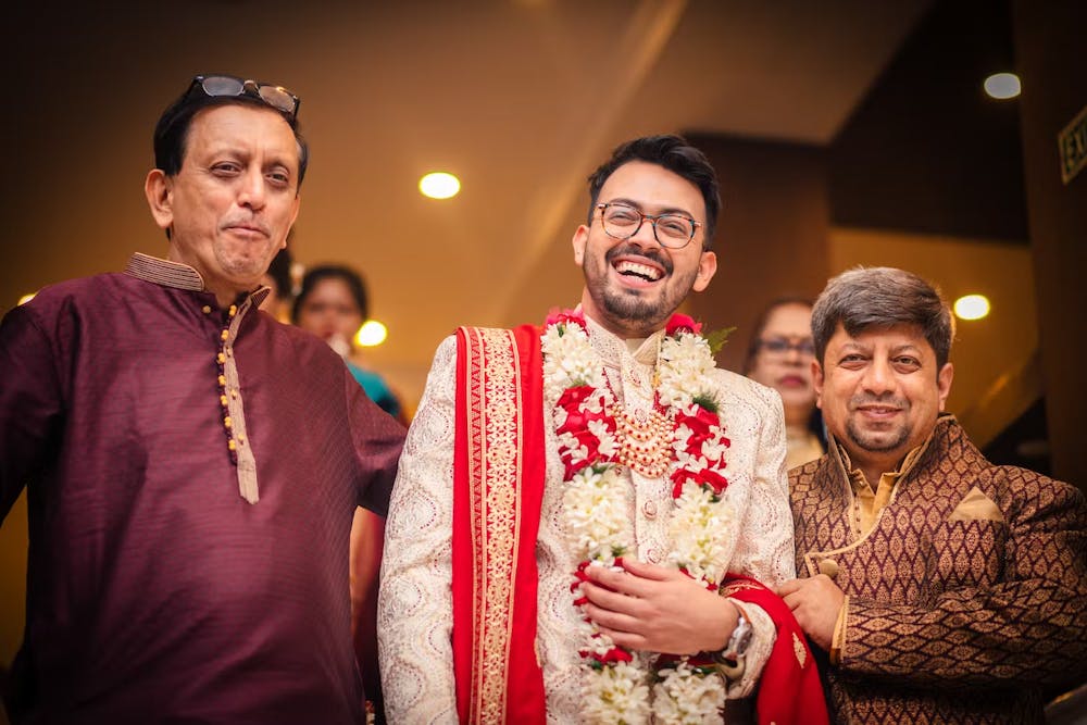 A smiling groom heading to his wedding venue