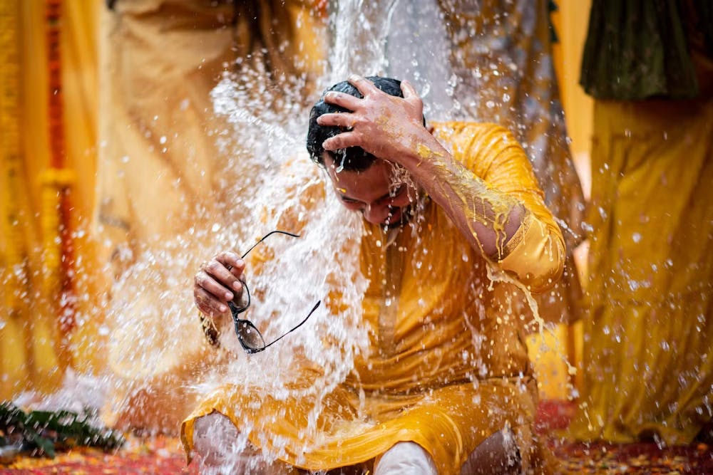 Groom showered with water on his Haldi day pic