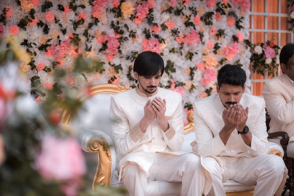Muslim groom praying to Allah with his brother before wedding pic