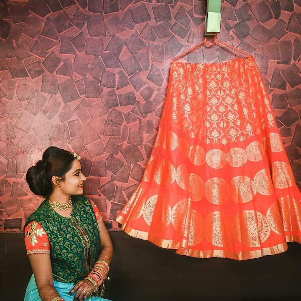 Bride candid posing with her wedding red lehenga