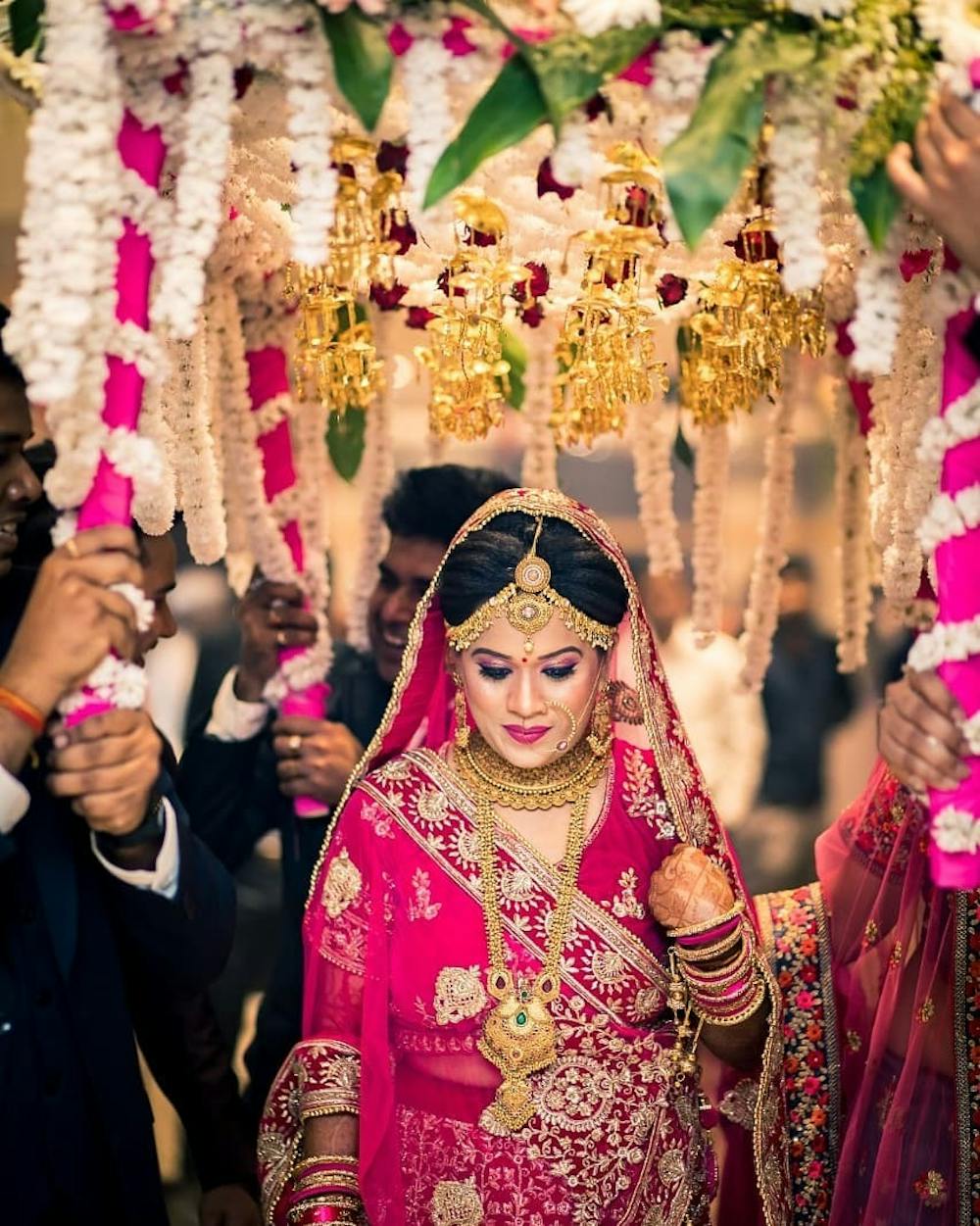 Bride wearing Pink lehenga in bridal entry pic