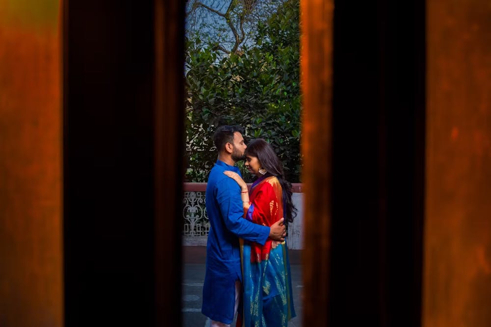 Groom kissing on the forehead of bride pic
