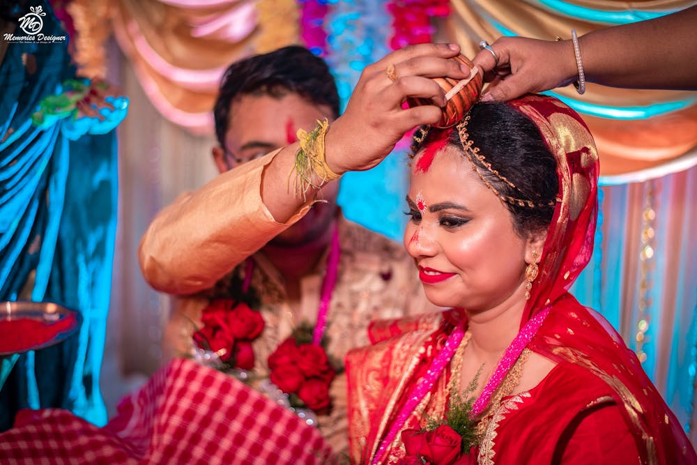 Groom applying Sindoor on Bride's forehead