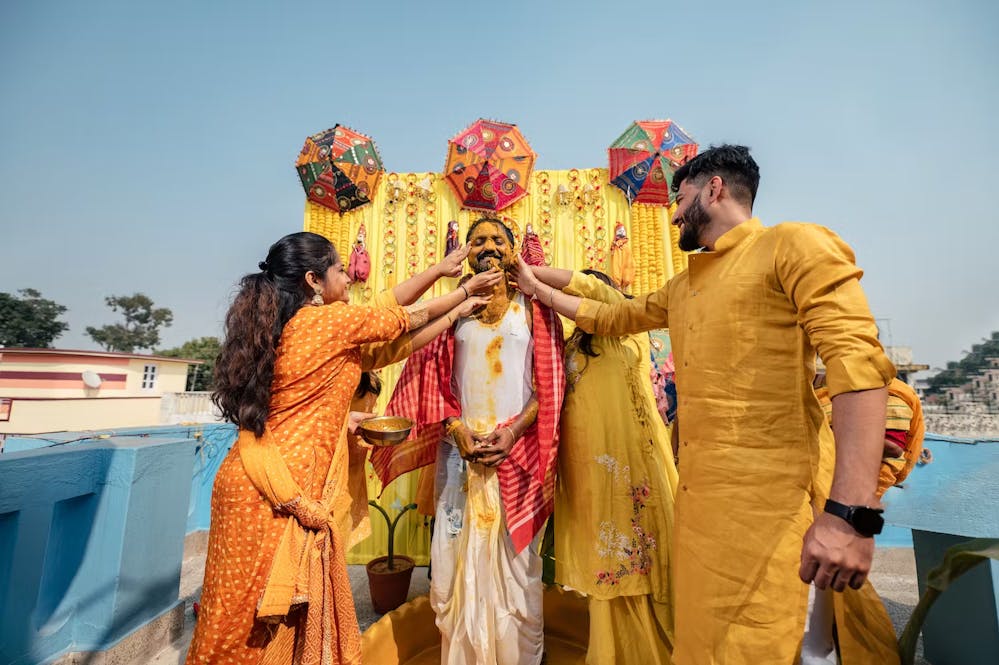 Close friends of groom posing for a candid photo in his Haldi function