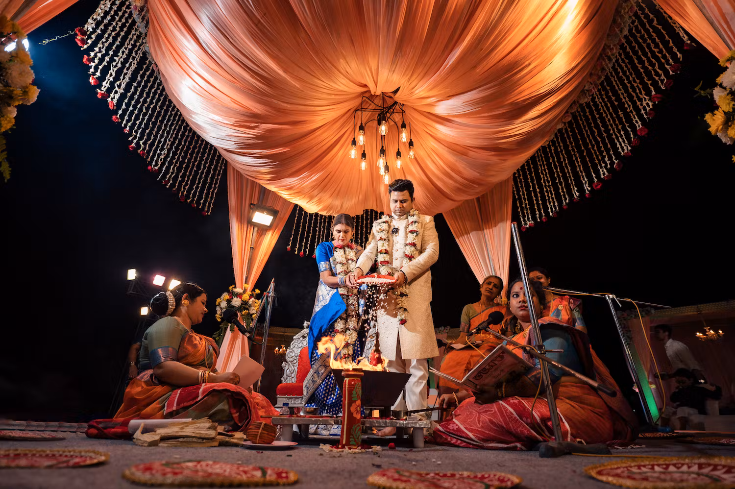 Priests chanting mantras while couple gets married