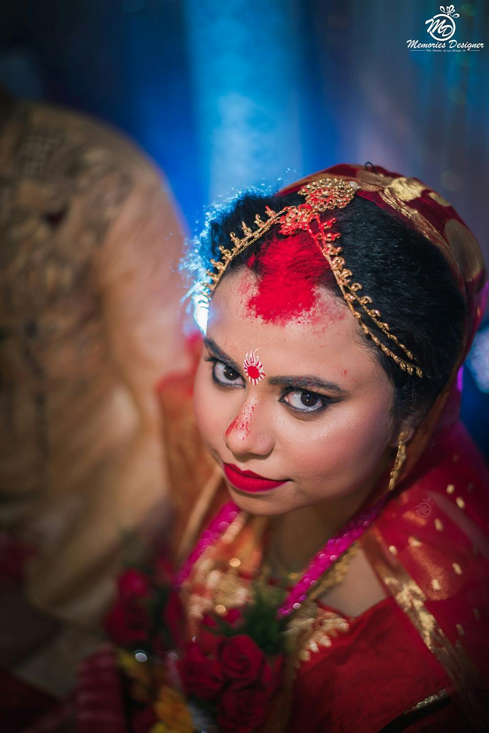A candid close-up shot of a bride wearing Sindoor on her wedding ceremony pic
