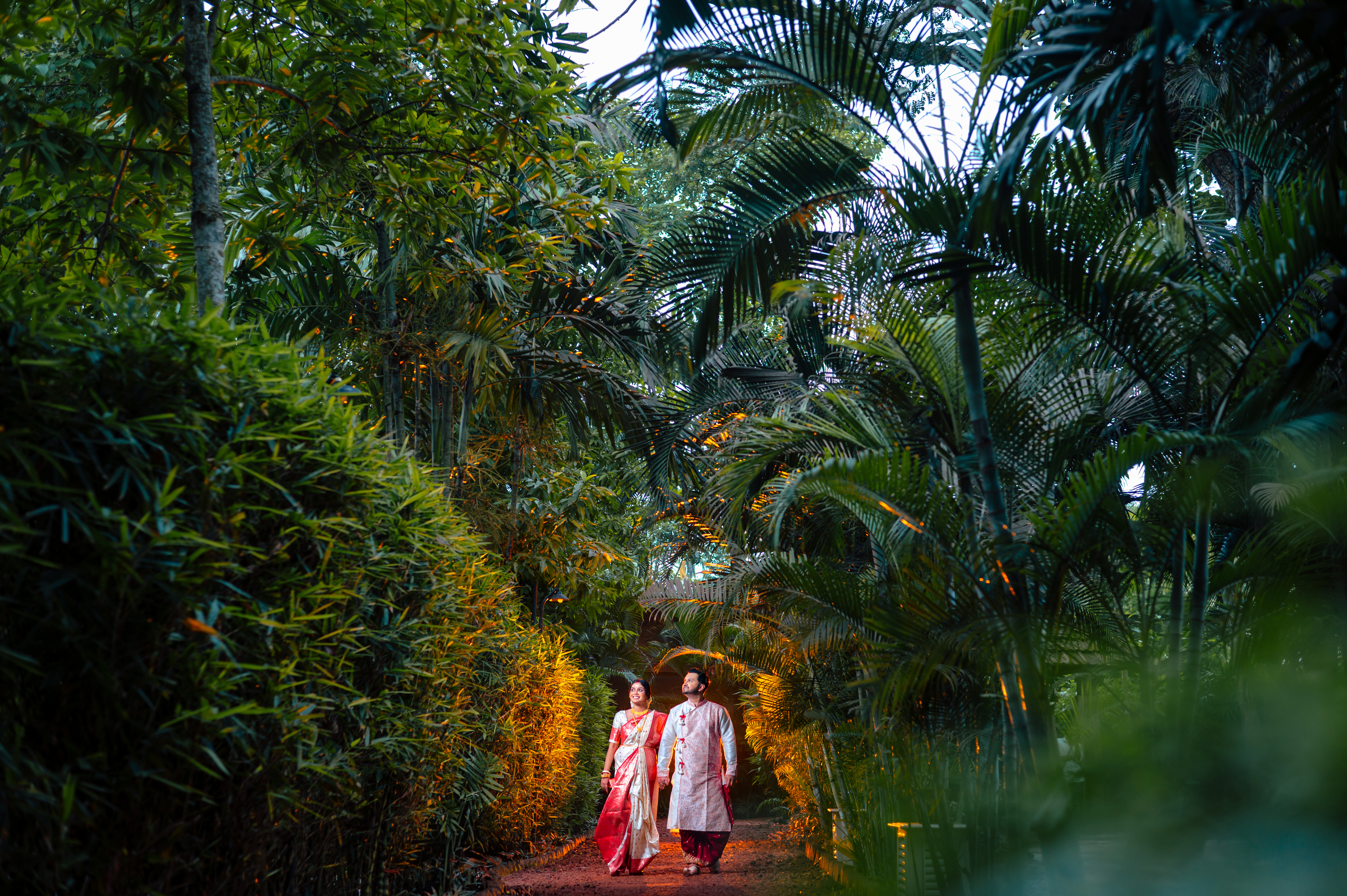 Bengali couple walking around nature during pre wedding photoshoot at Bawali Rajbari heritage location | Memories Designer
