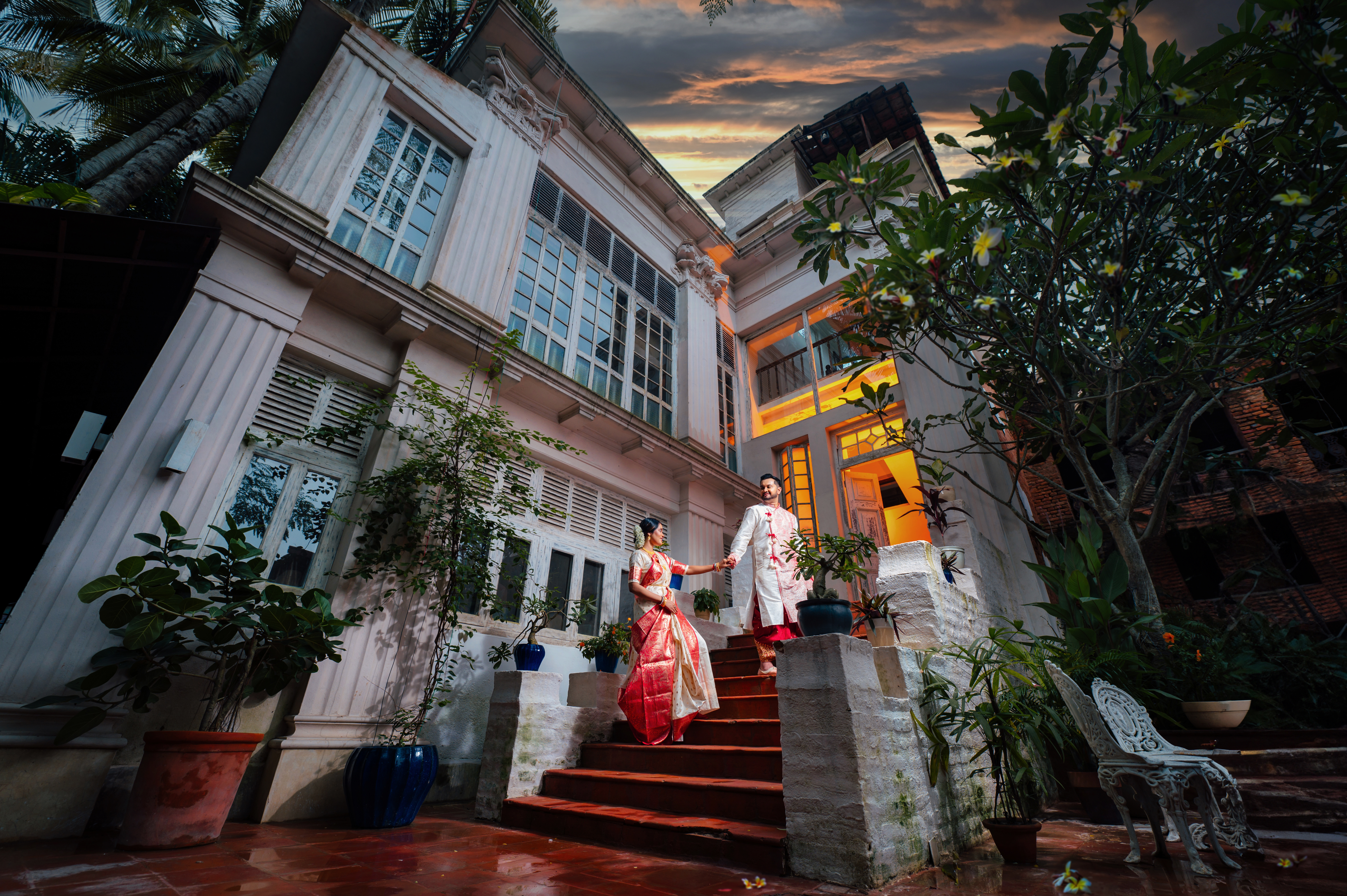 Bengali couple going up the staircase during pre wedding photoshoot at Bawali Rajbari heritage location | Memories Designer