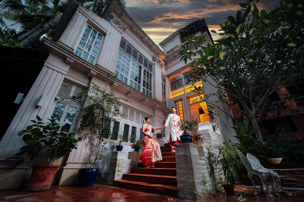 Bengali couple going up the staircase during pre wedding photoshoot at Bawali Rajbari heritage location | Memories Designer