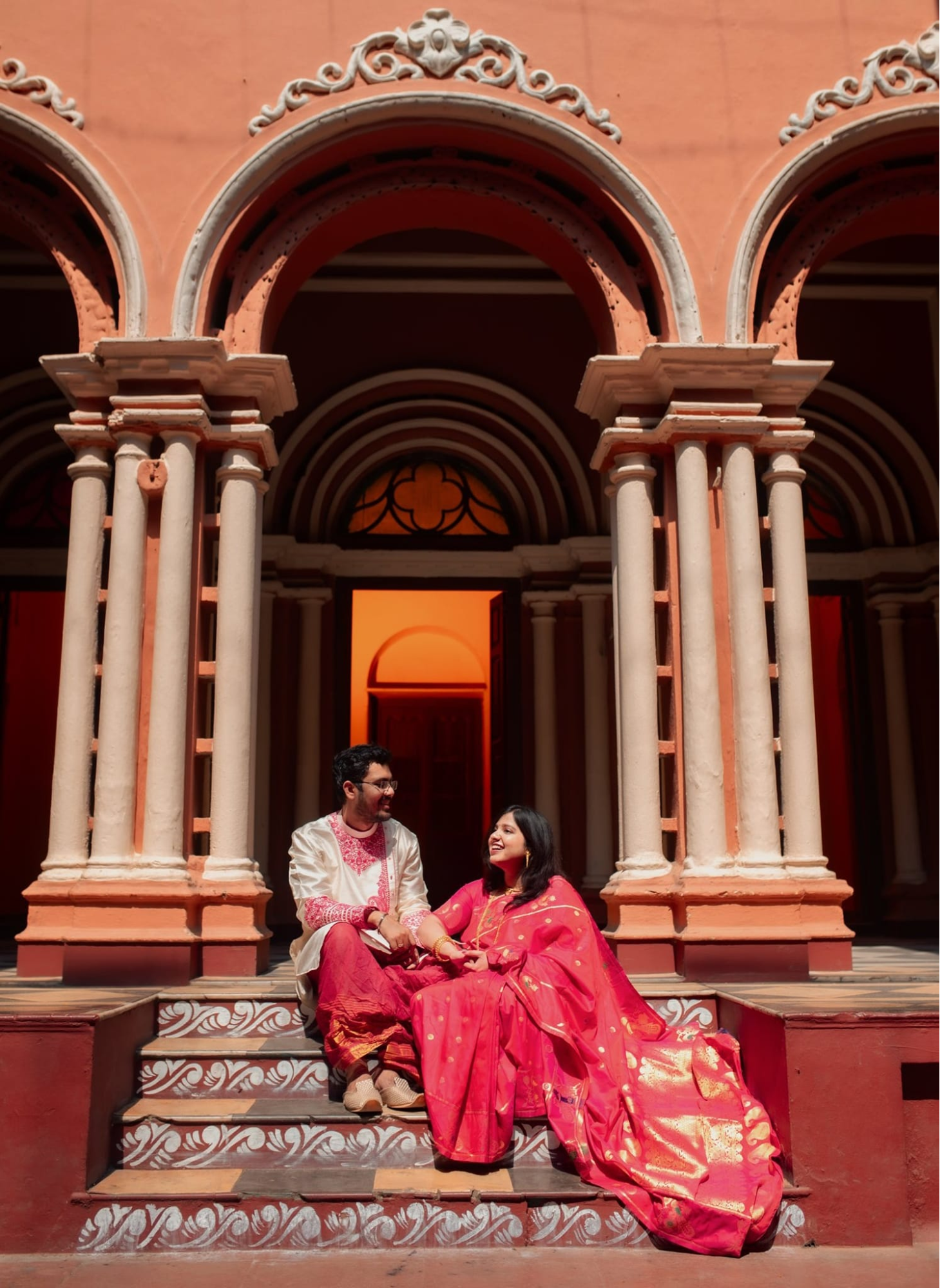Young couple chatting on the stairs at North Kolkata Pre-Wedding Photoshoot | Memories Designer