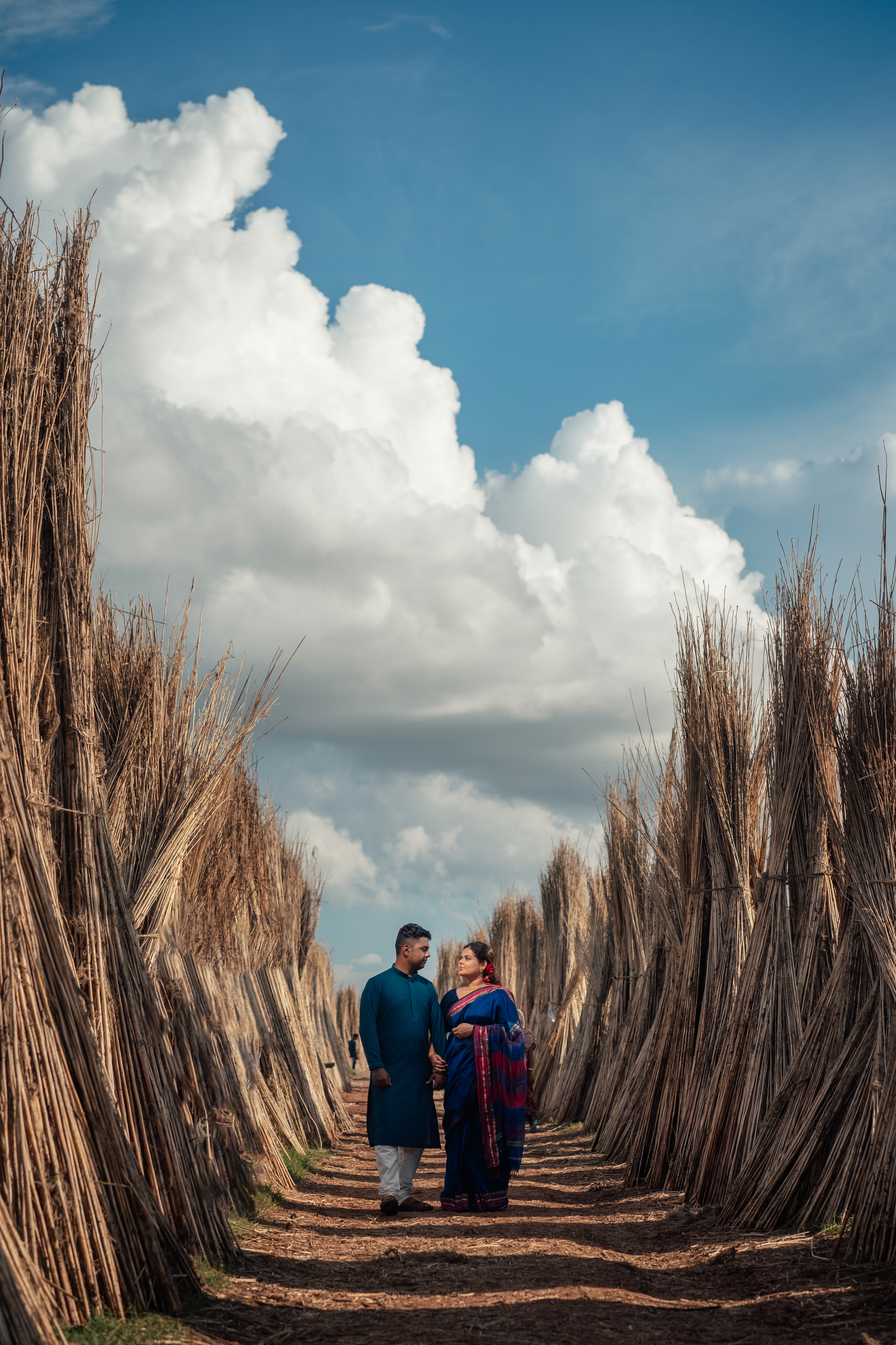 Bengali Couple walking on the fields Pre-Wedding Photoshoot | Memories Designer