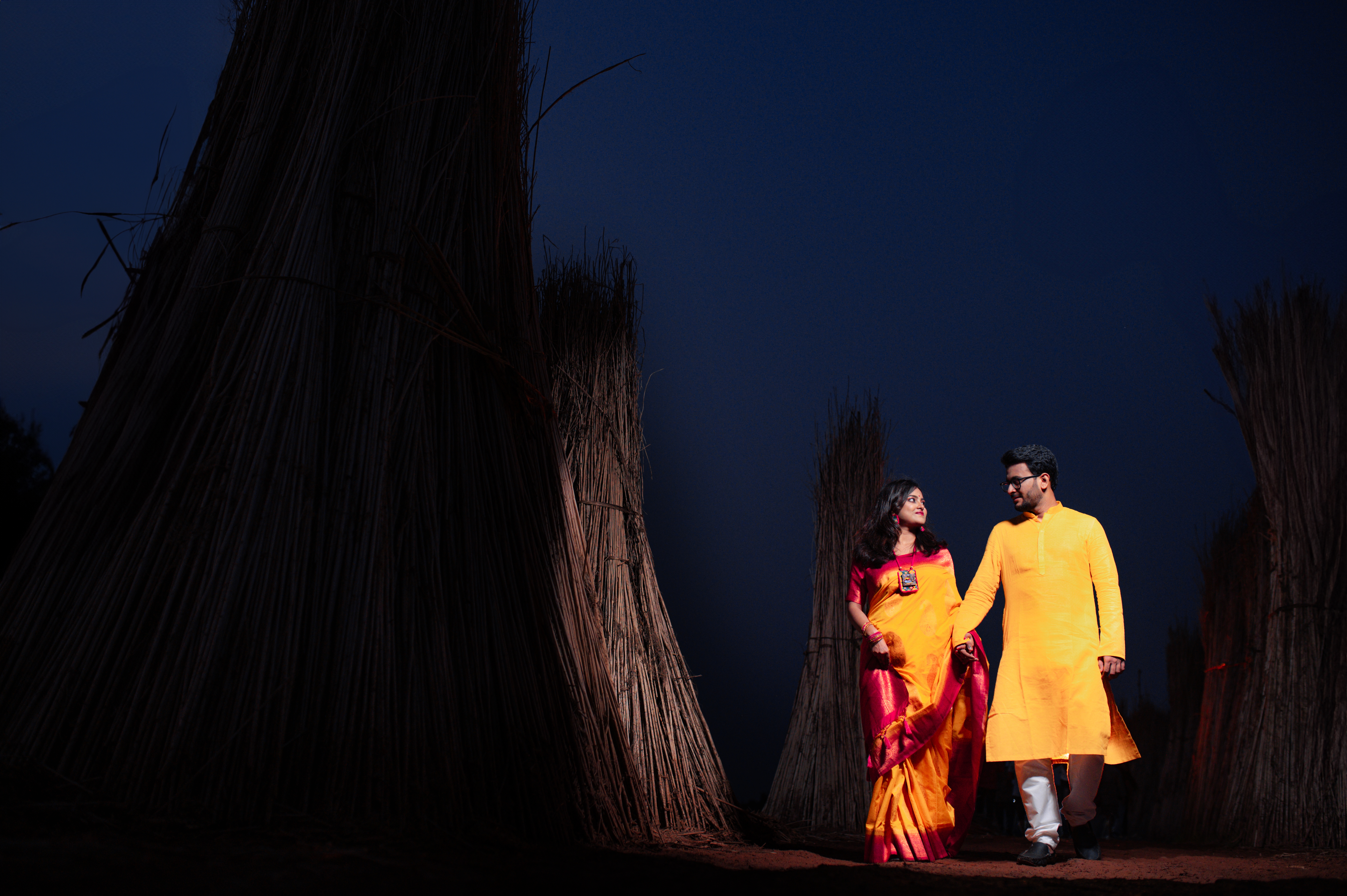 Bengali Couple walking on the fields under the sky Pre-Wedding Photoshoot | Memories Designer