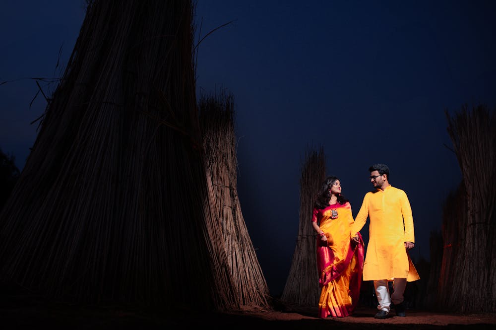 Bengali Couple walking on the fields under the sky Pre-Wedding Photoshoot | Memories Designer
