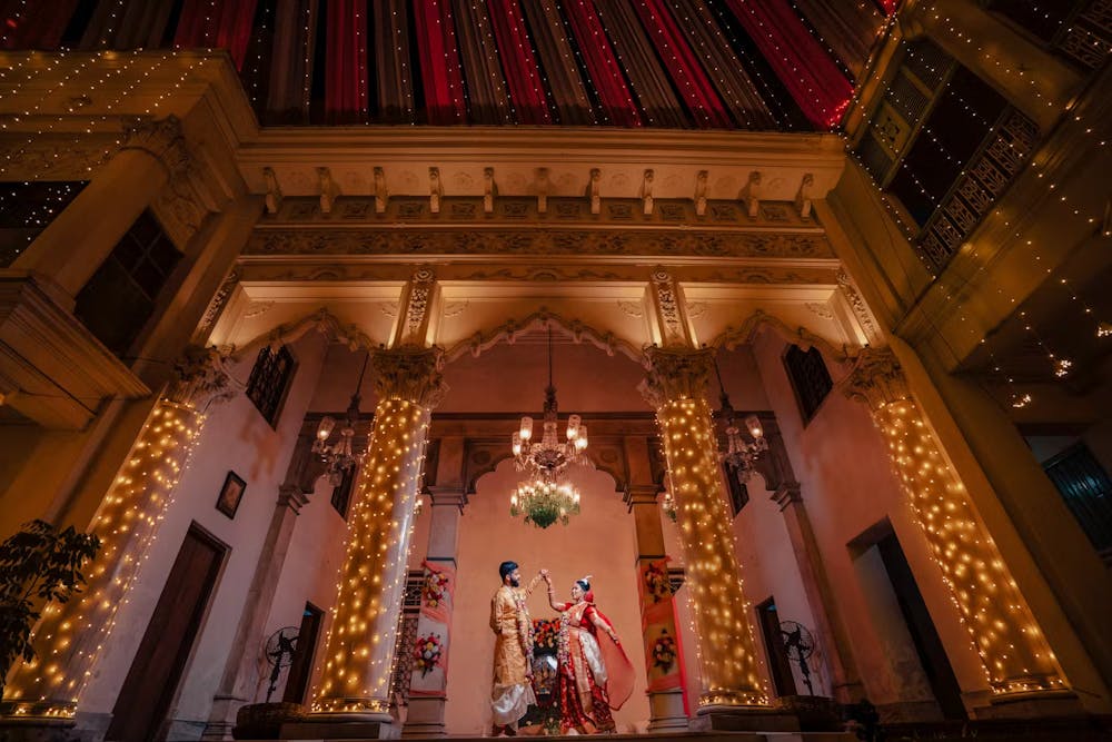Traditional bengali wedding photoshoot of couple dancing | Memories Designer