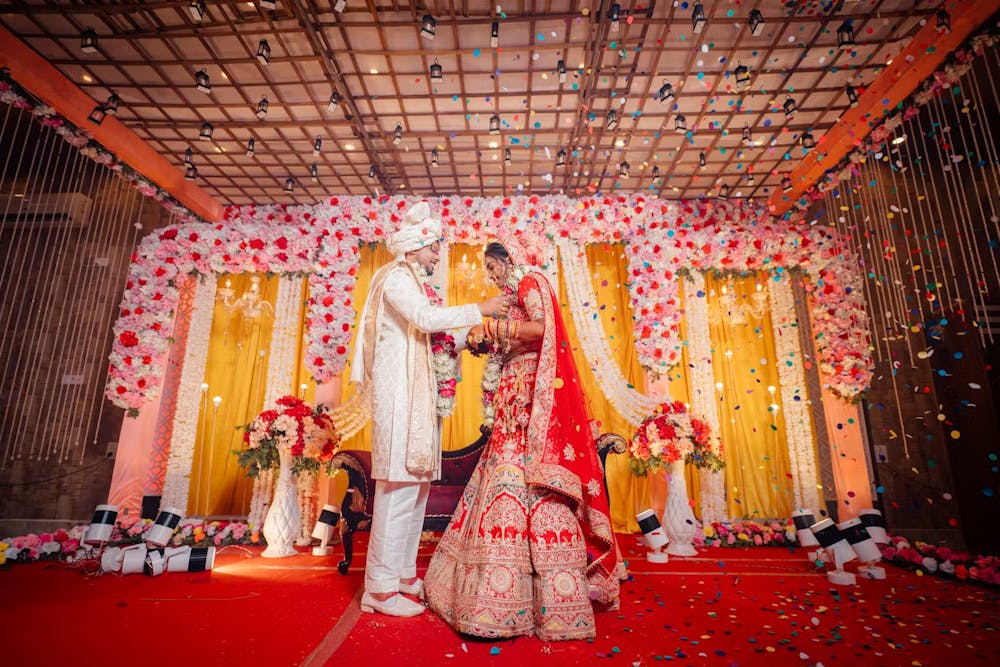 Confetti showed on Indian bride and groom during garland exchange | Cinematic wedding photoshoot | Memories Designer