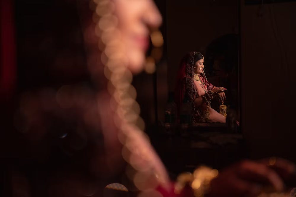 Reflection of Indian bride on the mirror | Cinematic wedding photoshoot | Memories Designer