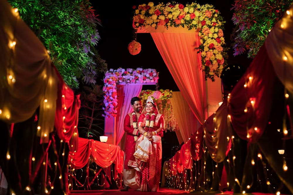 Bengali bride and groom at wedding venue with fairy lights | Cinematic wedding photoshoot | Memories Designer