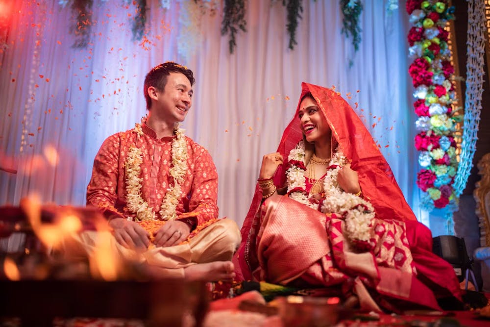 Indian couple smiling while looking at each other during wedding ceremony | Cinematic wedding photoshoot | Memories Designer