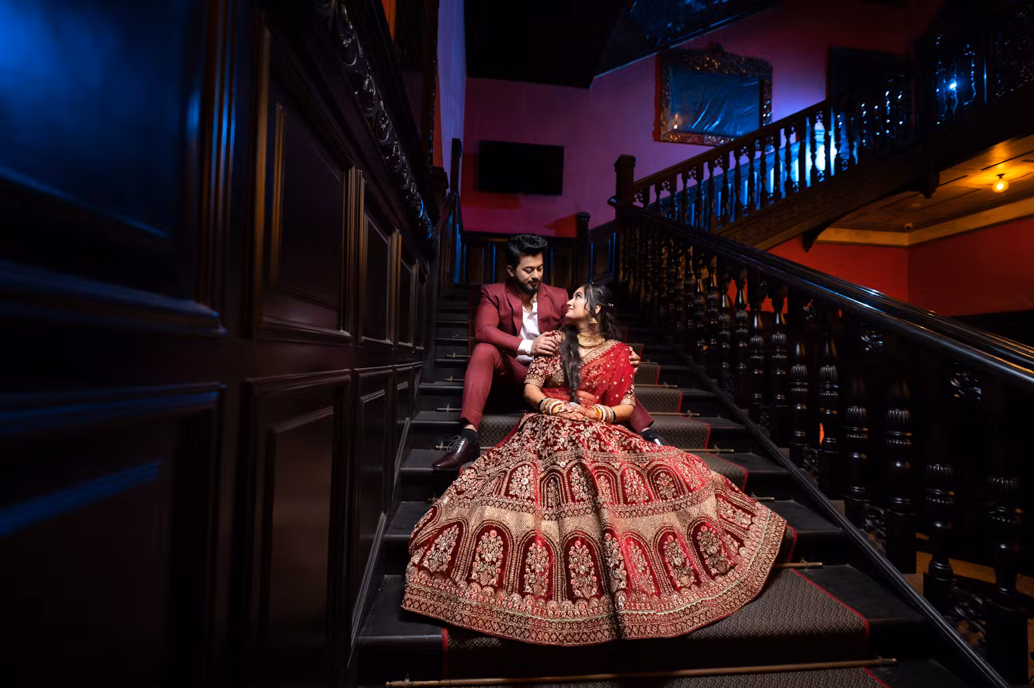 Indian bride and groom posing near stairs | Wedding reception | Memories Designer