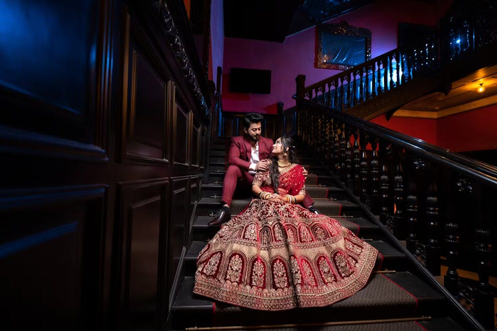 Indian bride and groom posing near stairs | Wedding reception | Memories Designer