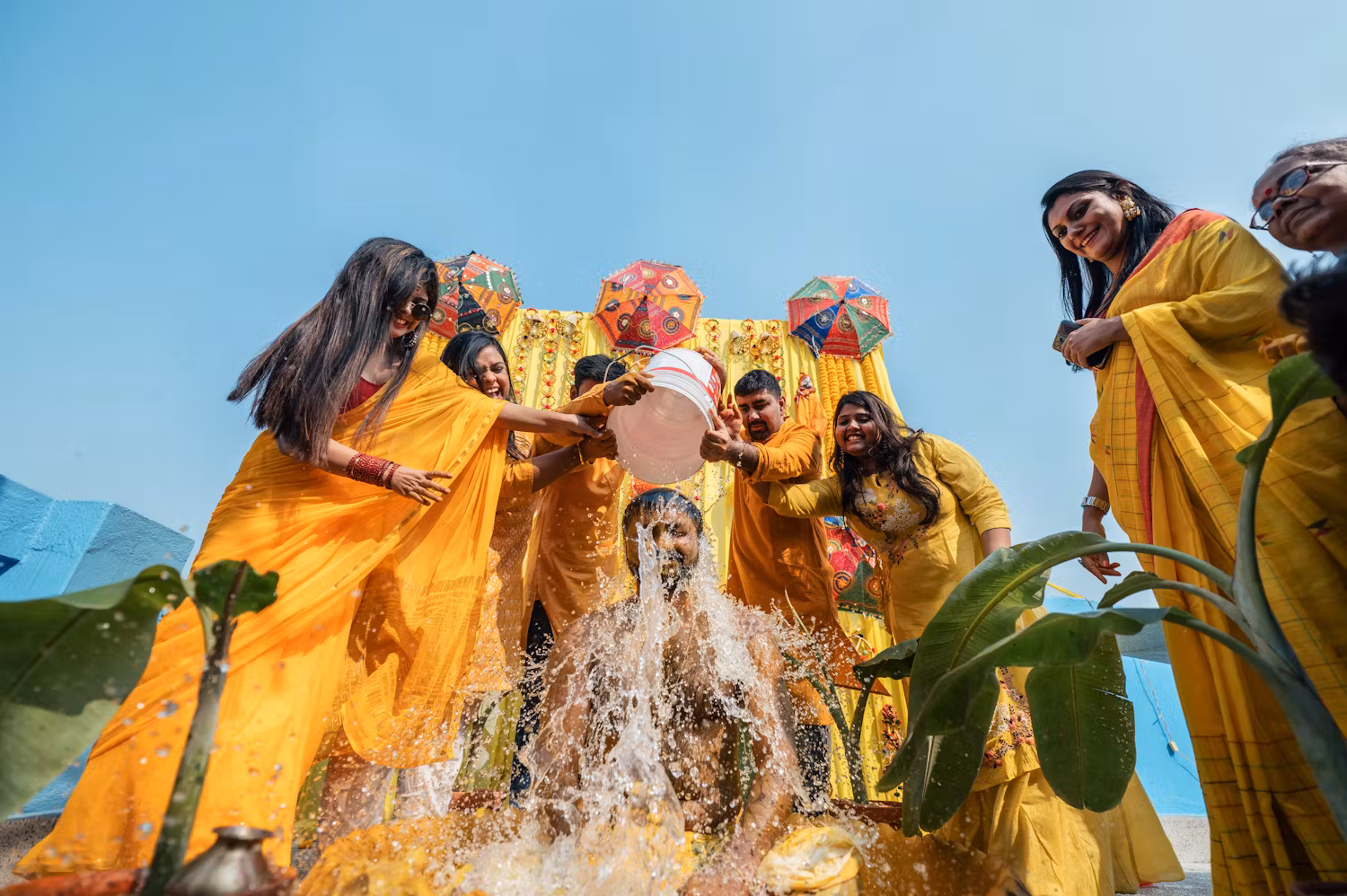 Funny wedding photography ideas for Indian Groom's Haldi ceremony with water splash | Memories Designer