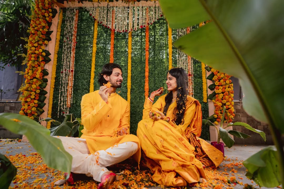 Funny wedding photography ideas where Indian bride and groom play with flowers | Memories Designer