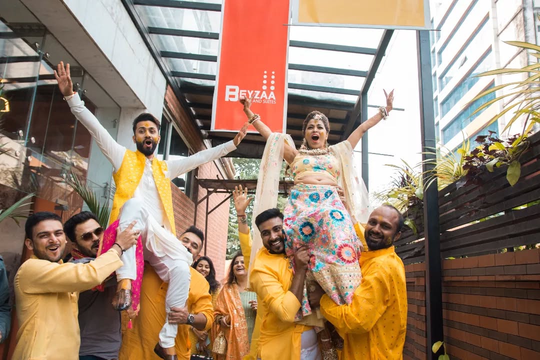 Funny wedding photography ideas of Indian bride and groom with friends and family at wedding ceremony.