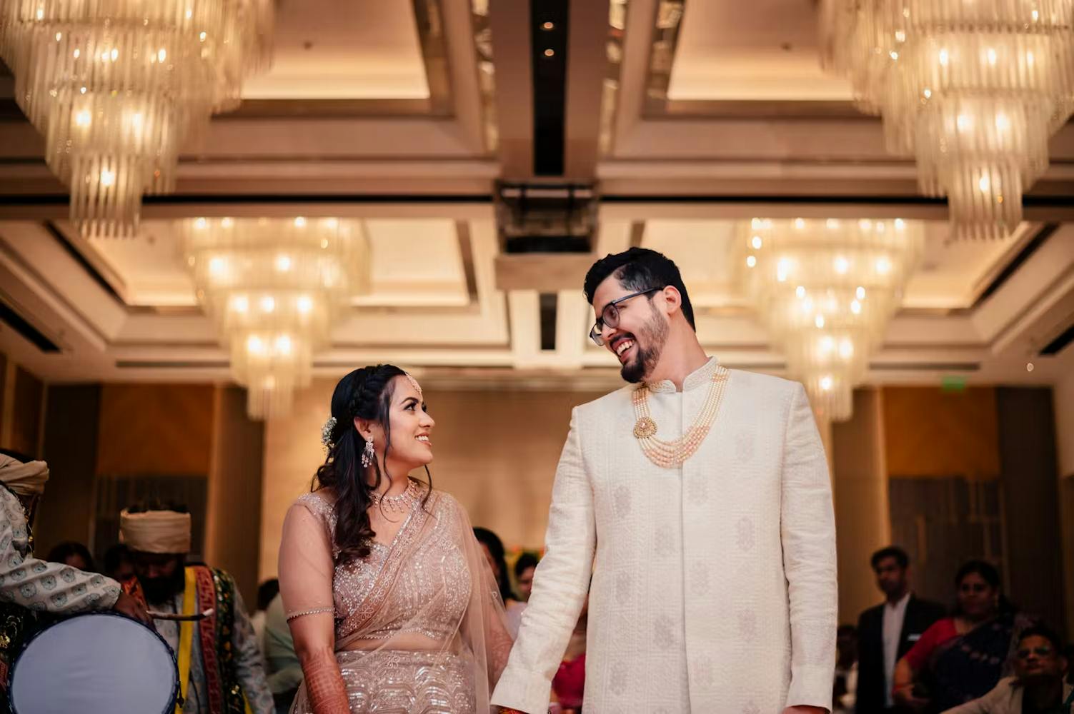 Groom holding hand of bride in reception function pic