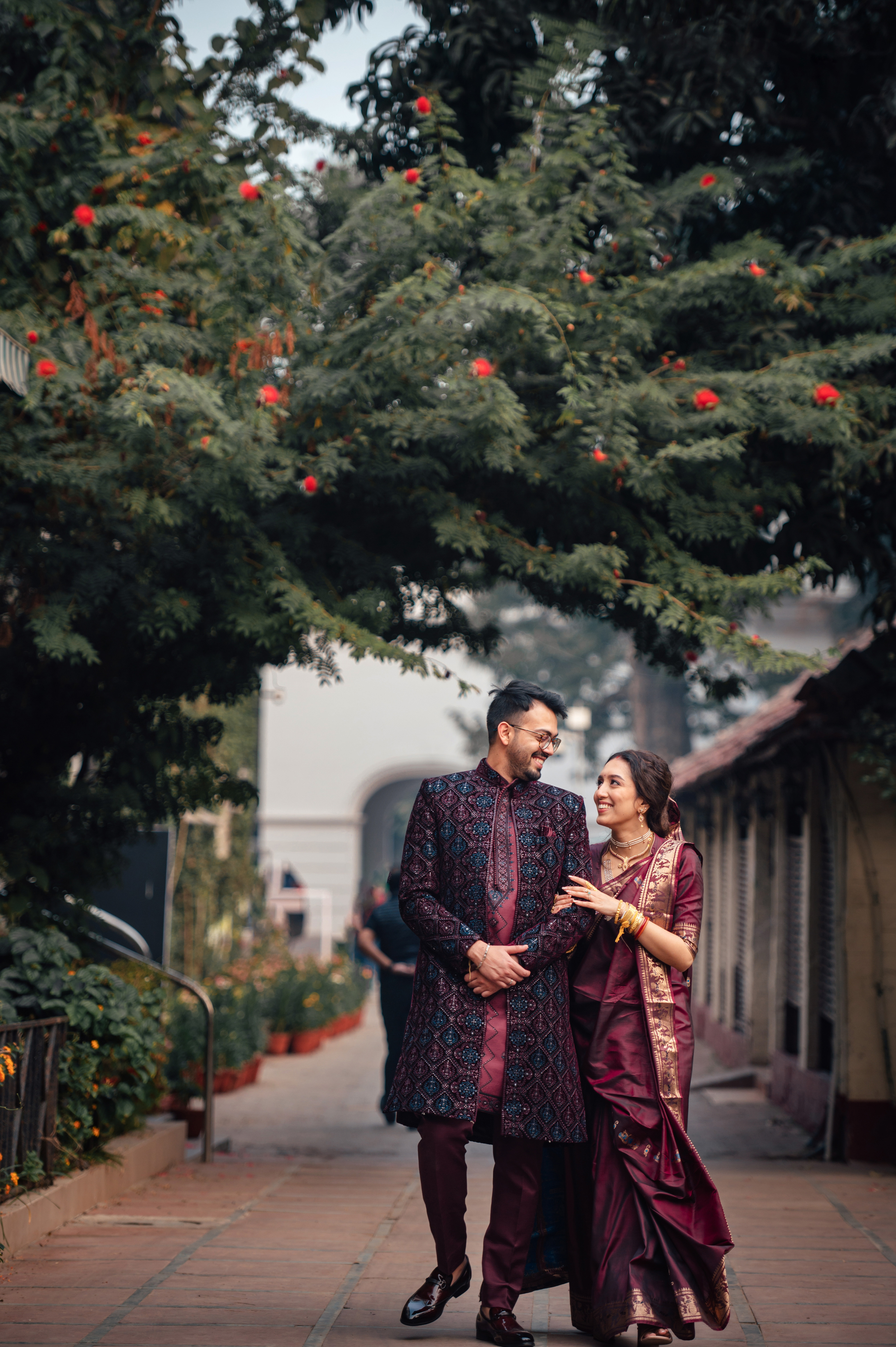 Groom in purple Anghrakha with bride image