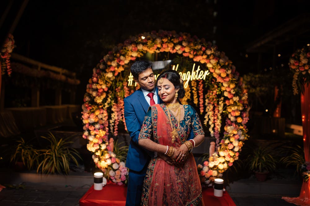 Groom acing his reception in a blue blazer with bride