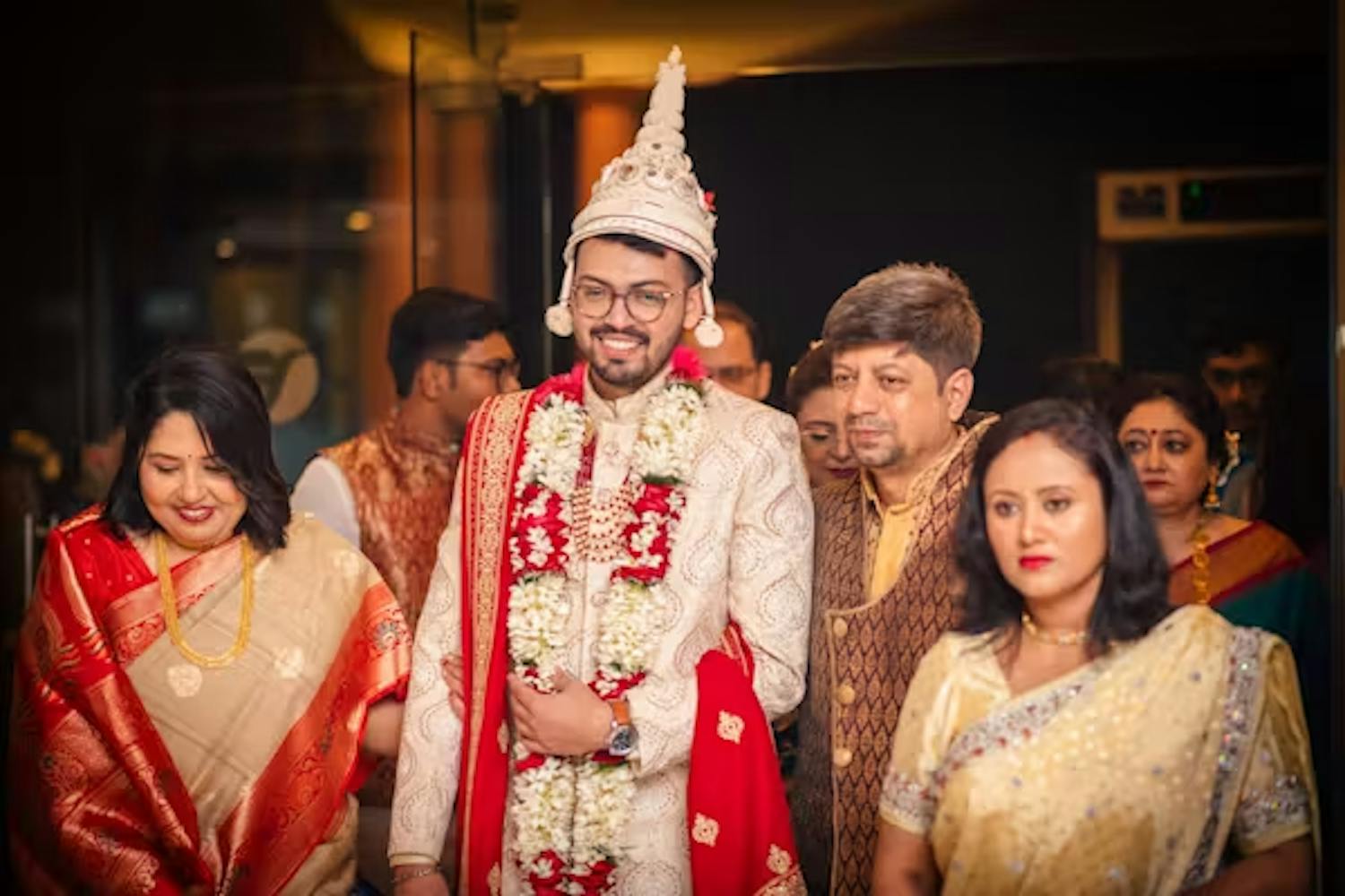 Groom with family on wedding day photoshoot