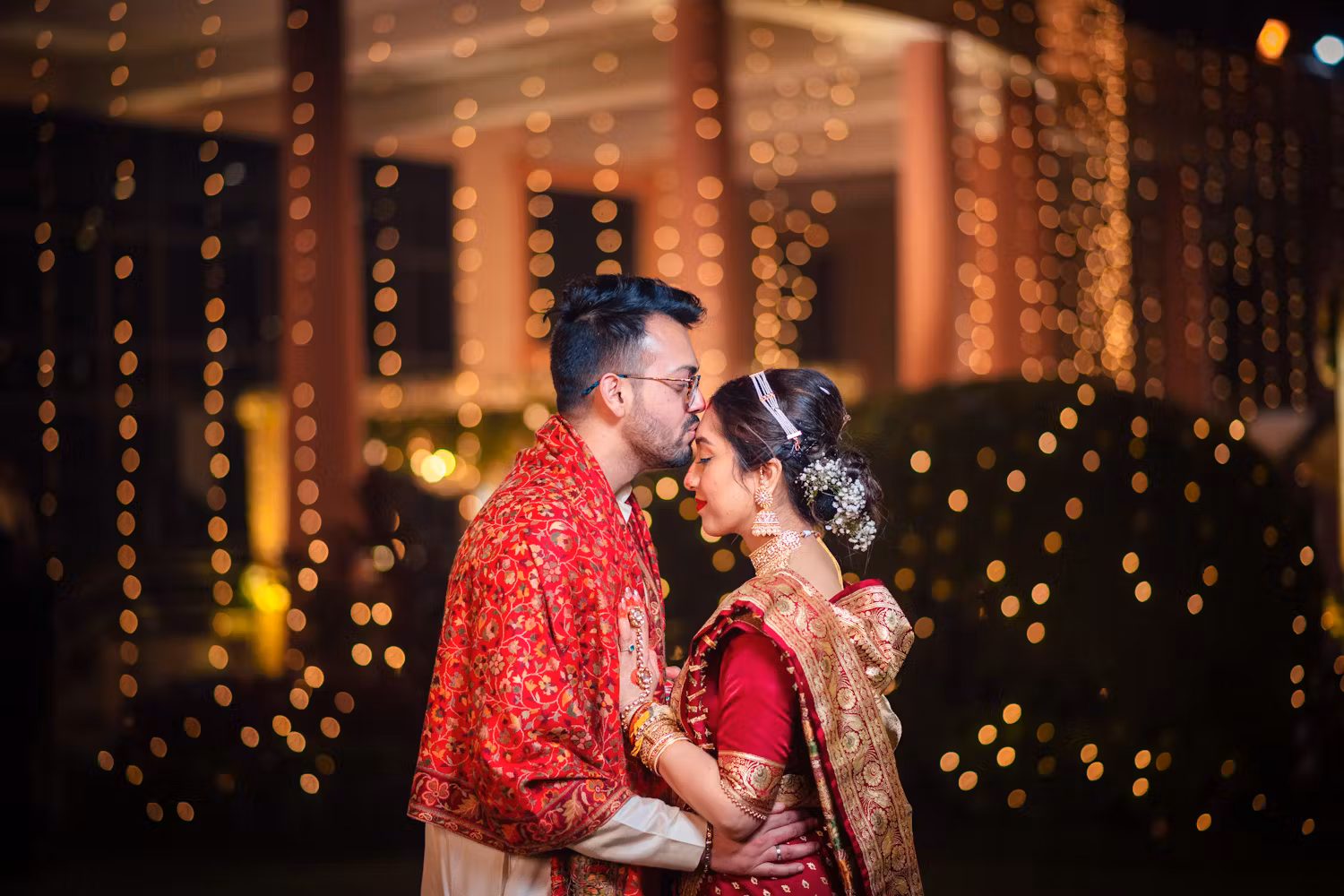 Groom kissing bride's forehead wedding pic