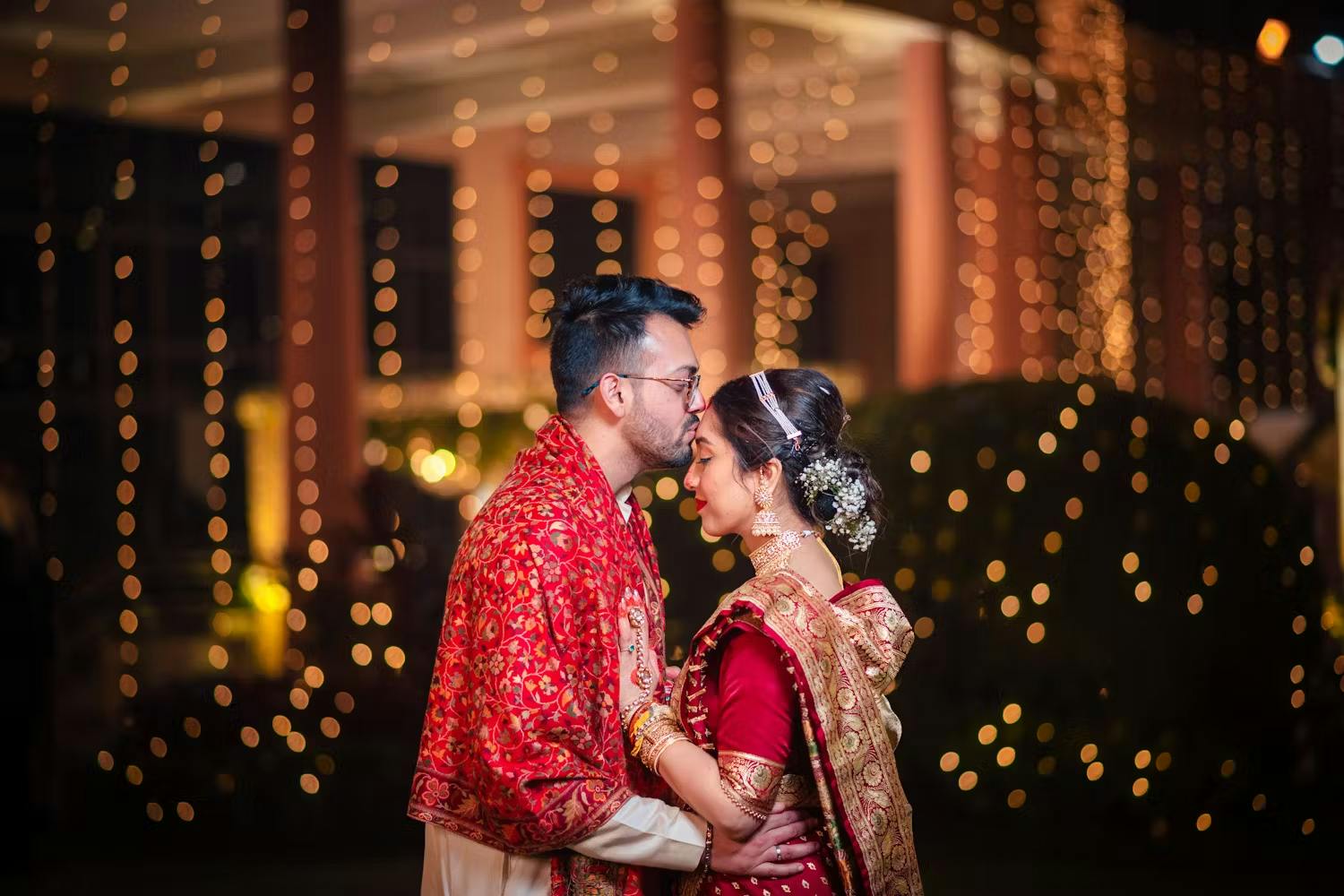 Groom kissing bride's forehead wedding pic