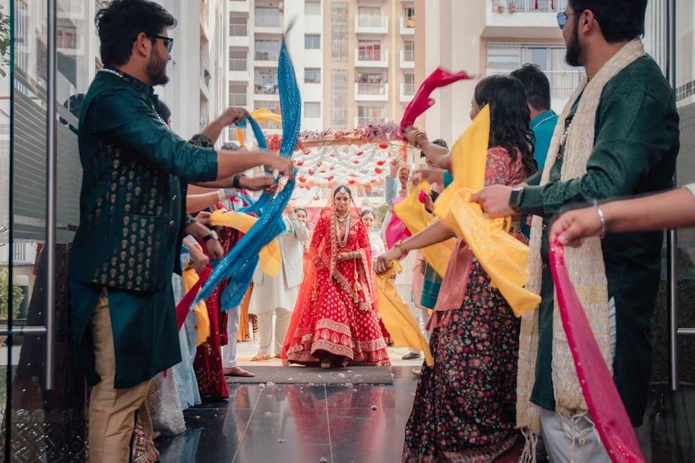 Colour-splashed bride climbing stairs