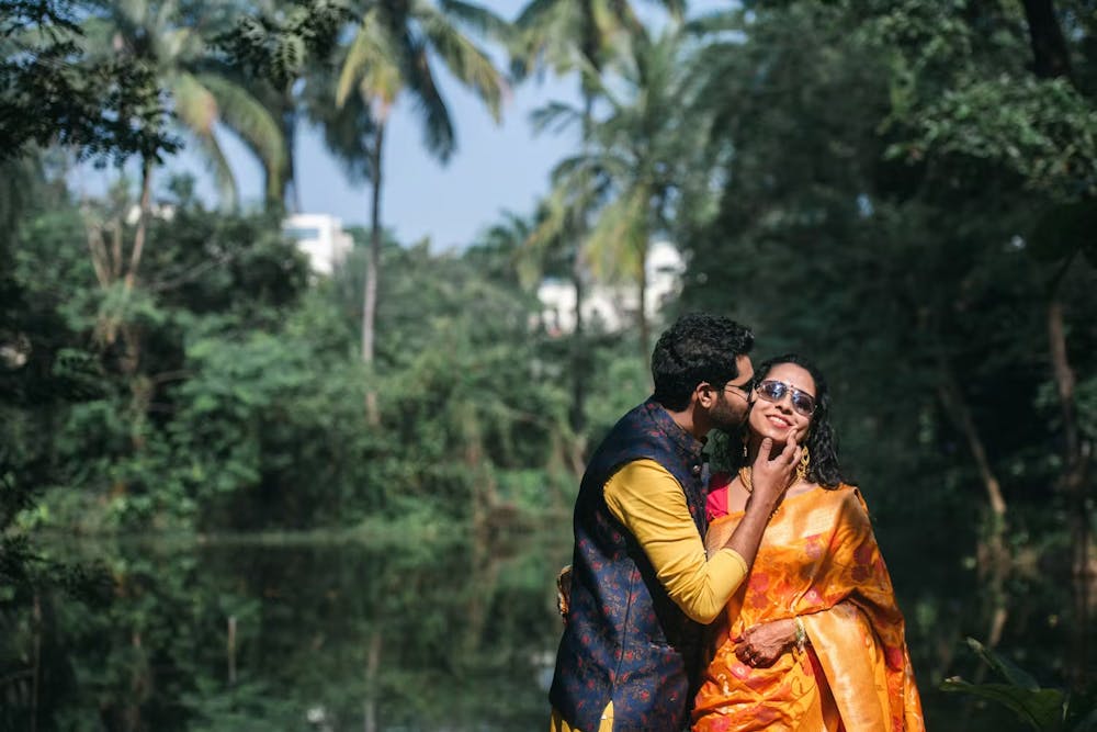 Groom kissing bride on Haldi day pic