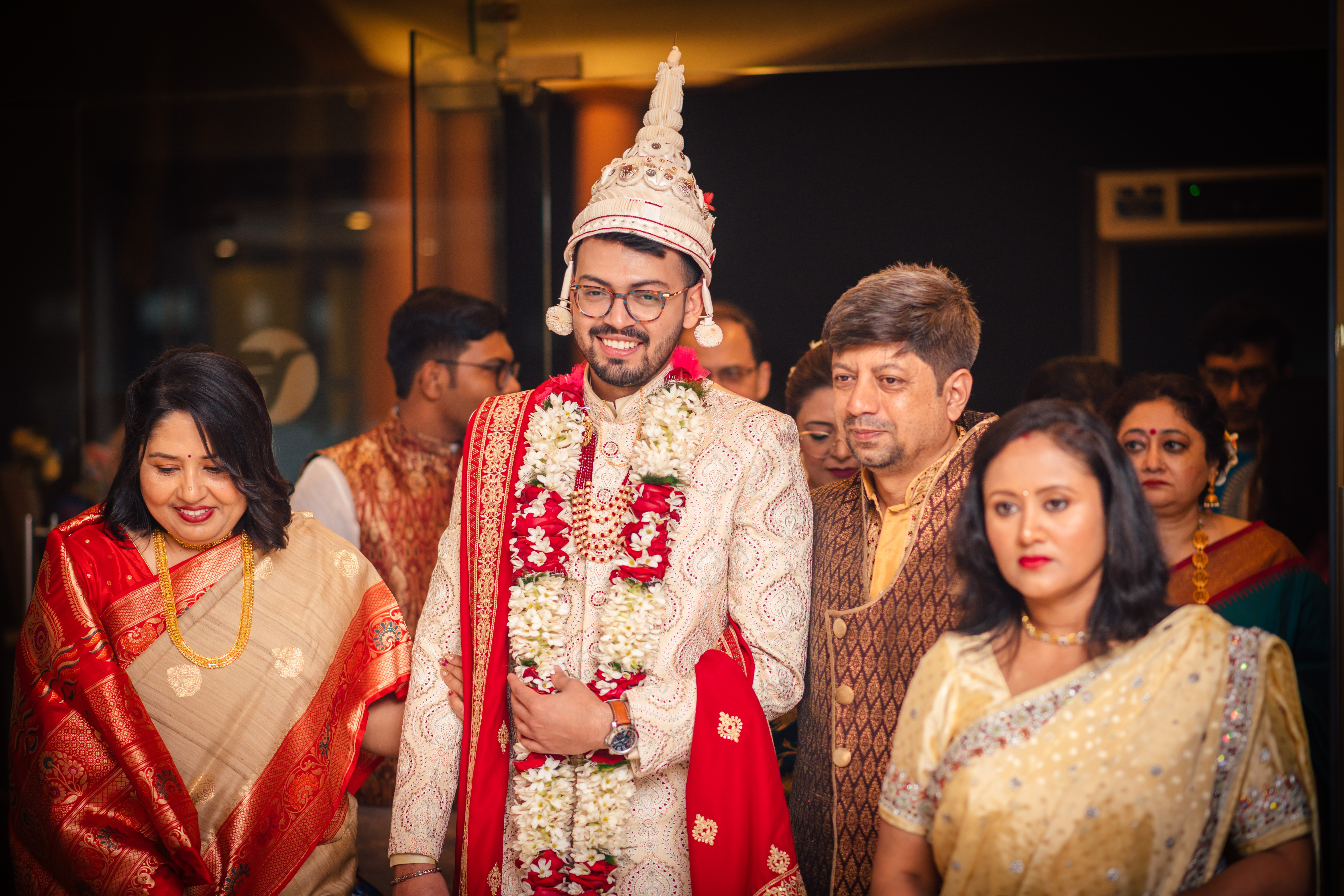 Groom with family on wedding day photoshoot