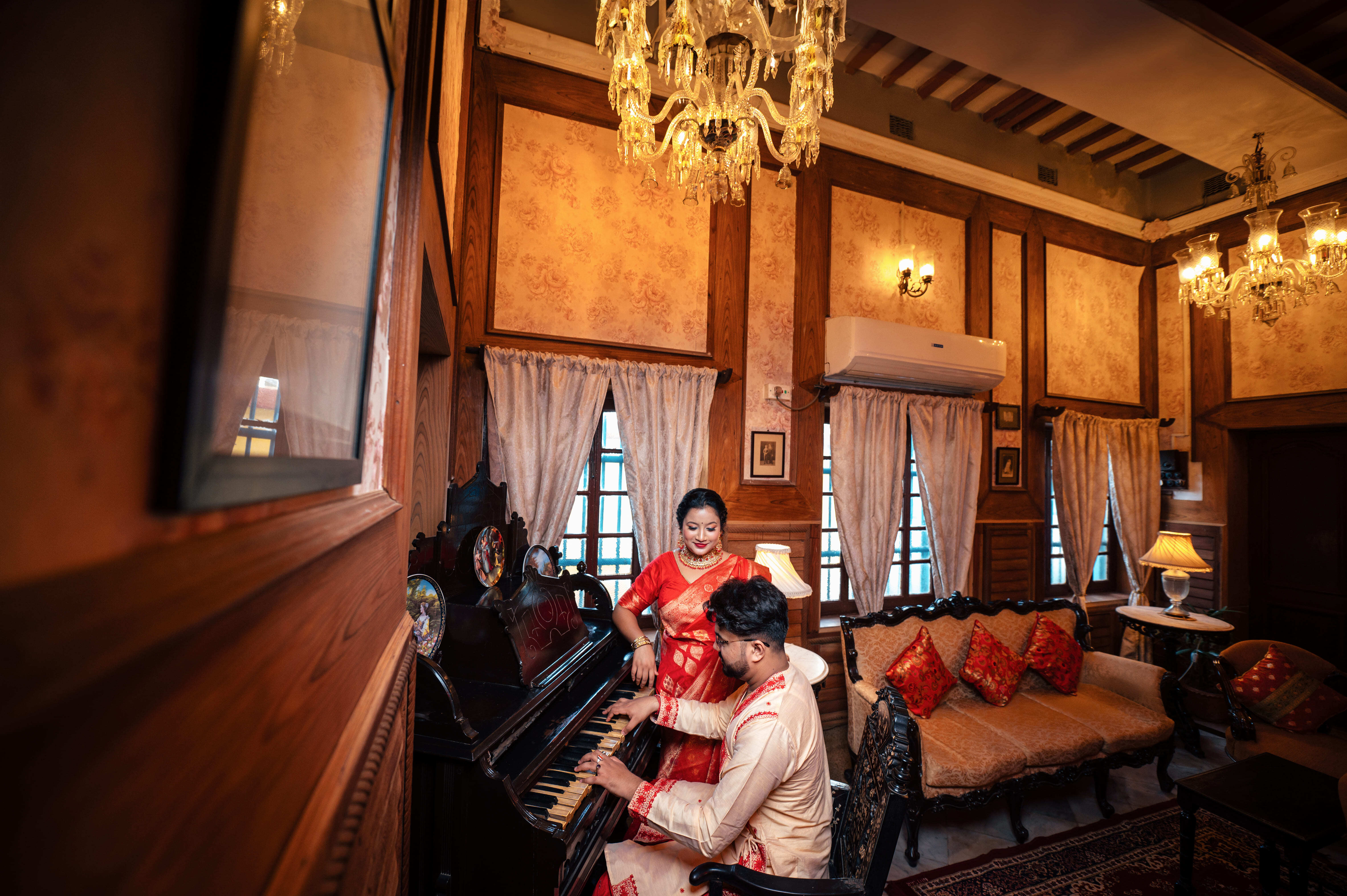 Groom playing music on piano in Bari Kothi Rajbari pic
