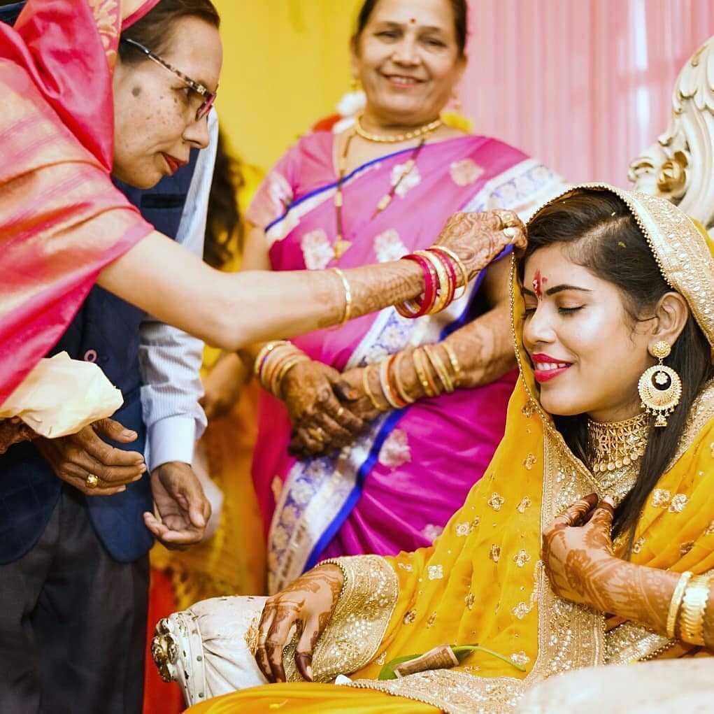 Bengali bride getting blessings from elders