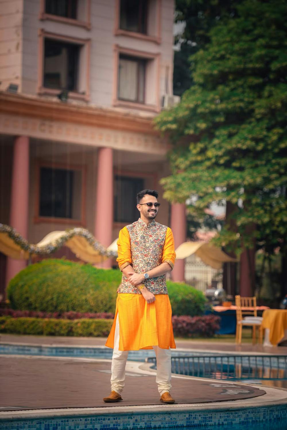 Groom striking a proud pose with sunglasses on his Haldi ceremony