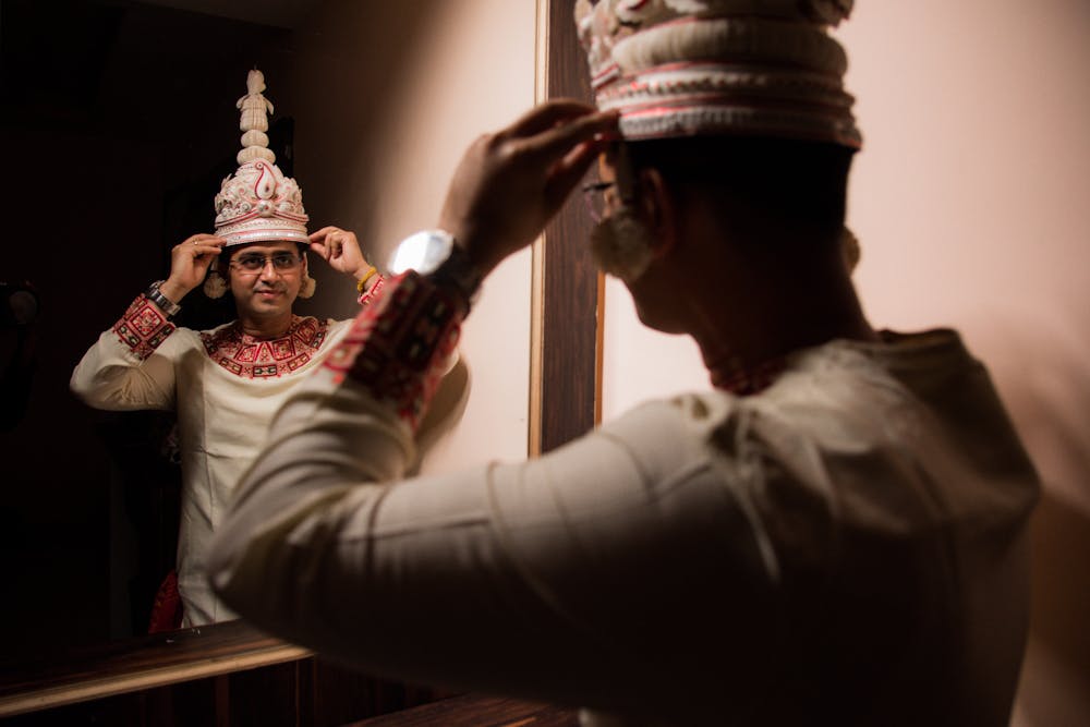 a MIRROR REFLECTION PHOTO OF A GROOM