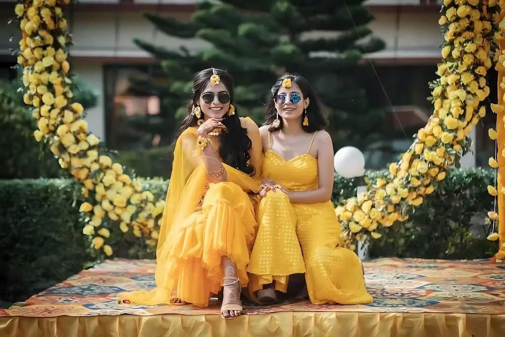 Bride posing with sister for Haldi pose