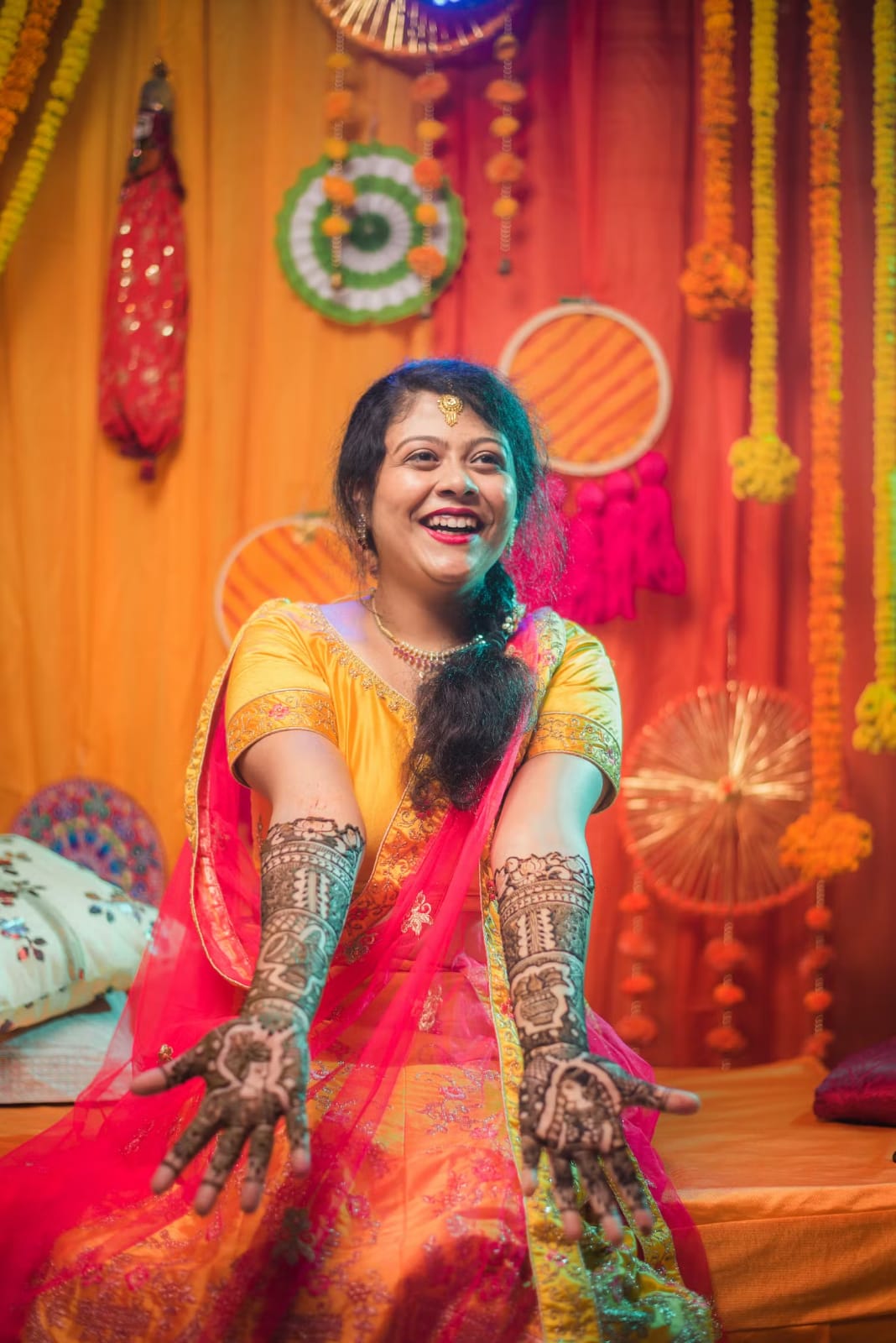 Pic of smiling bride with mehndi on her hands