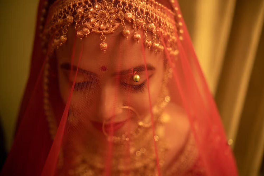 Bride shying under her veil pic