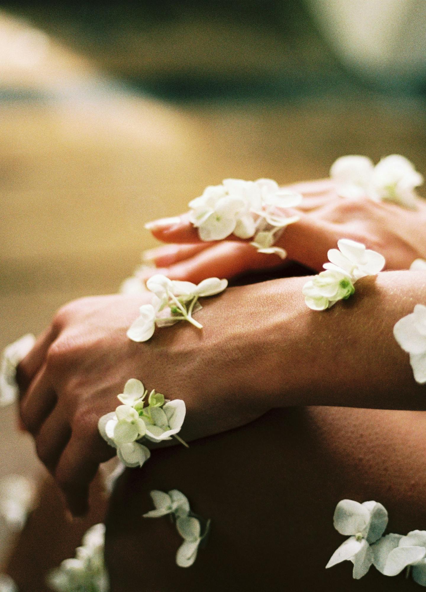 Side profile of an arm covering in delicate white flowers