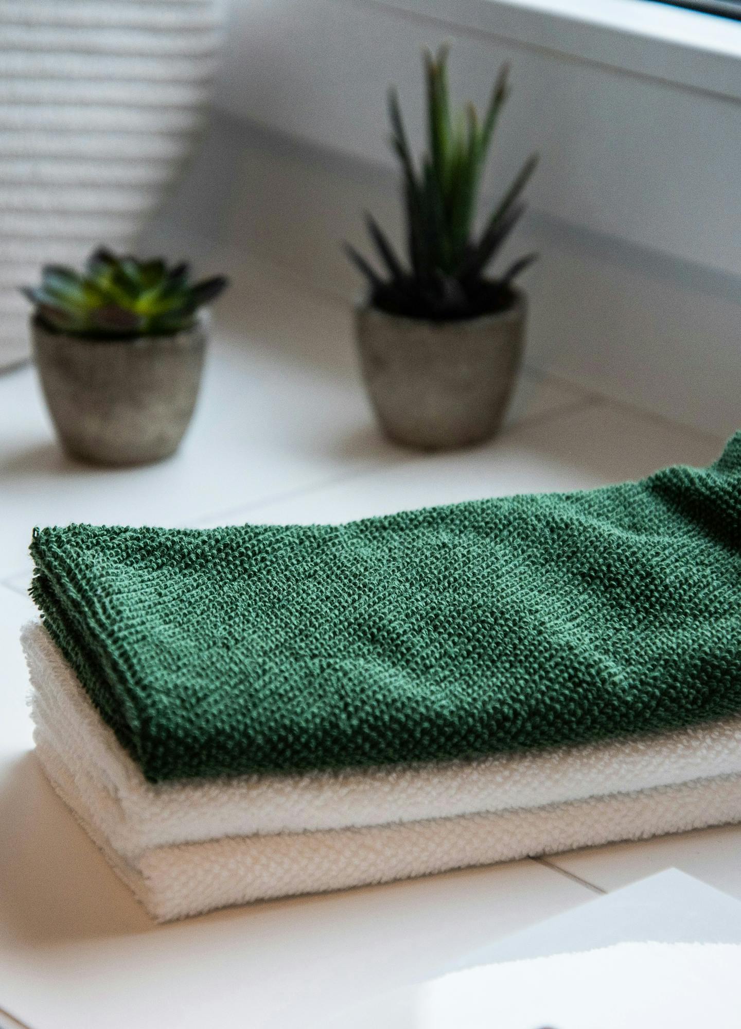 Green and white spa towels neatly folded