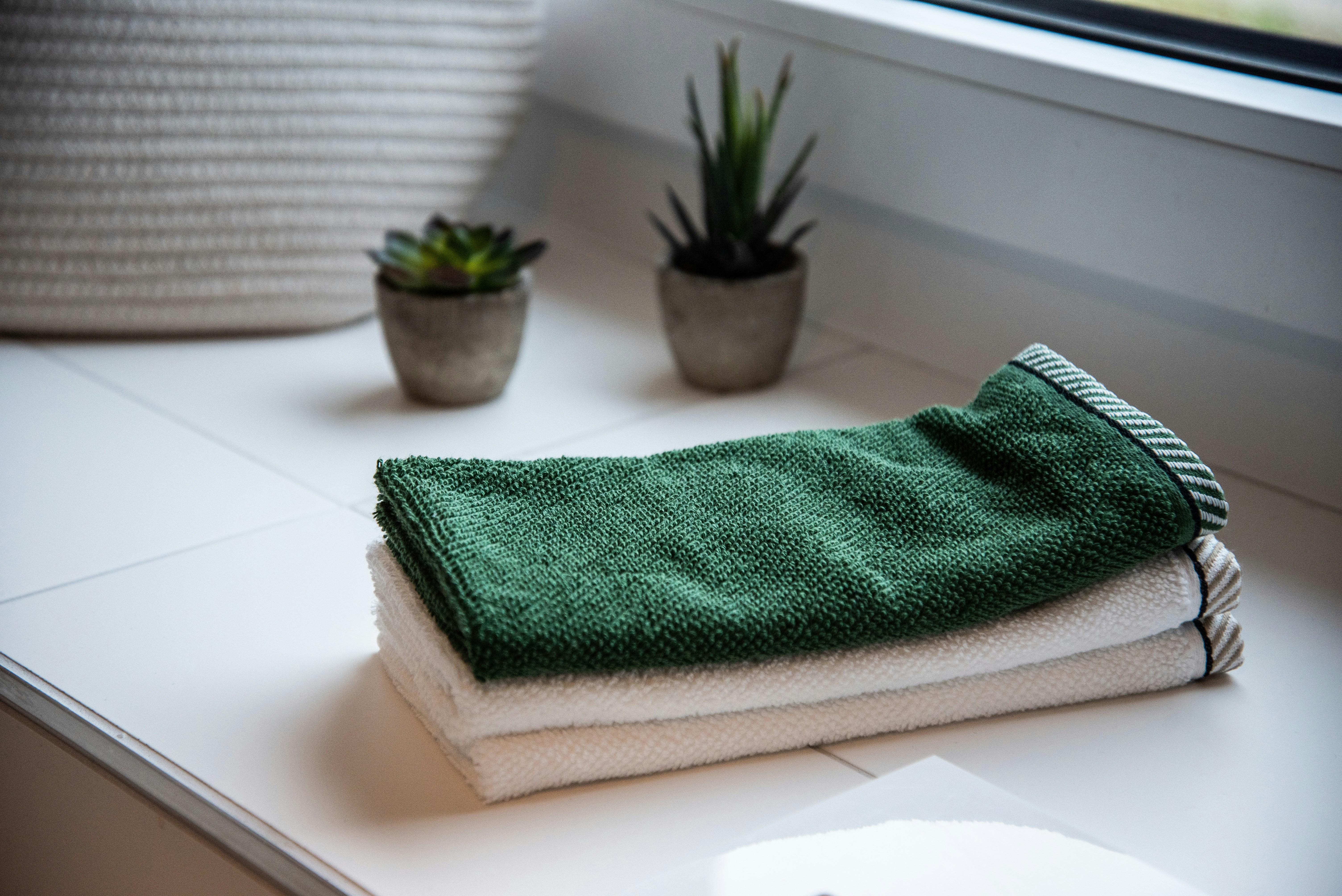 Green and white spa towels neatly folded