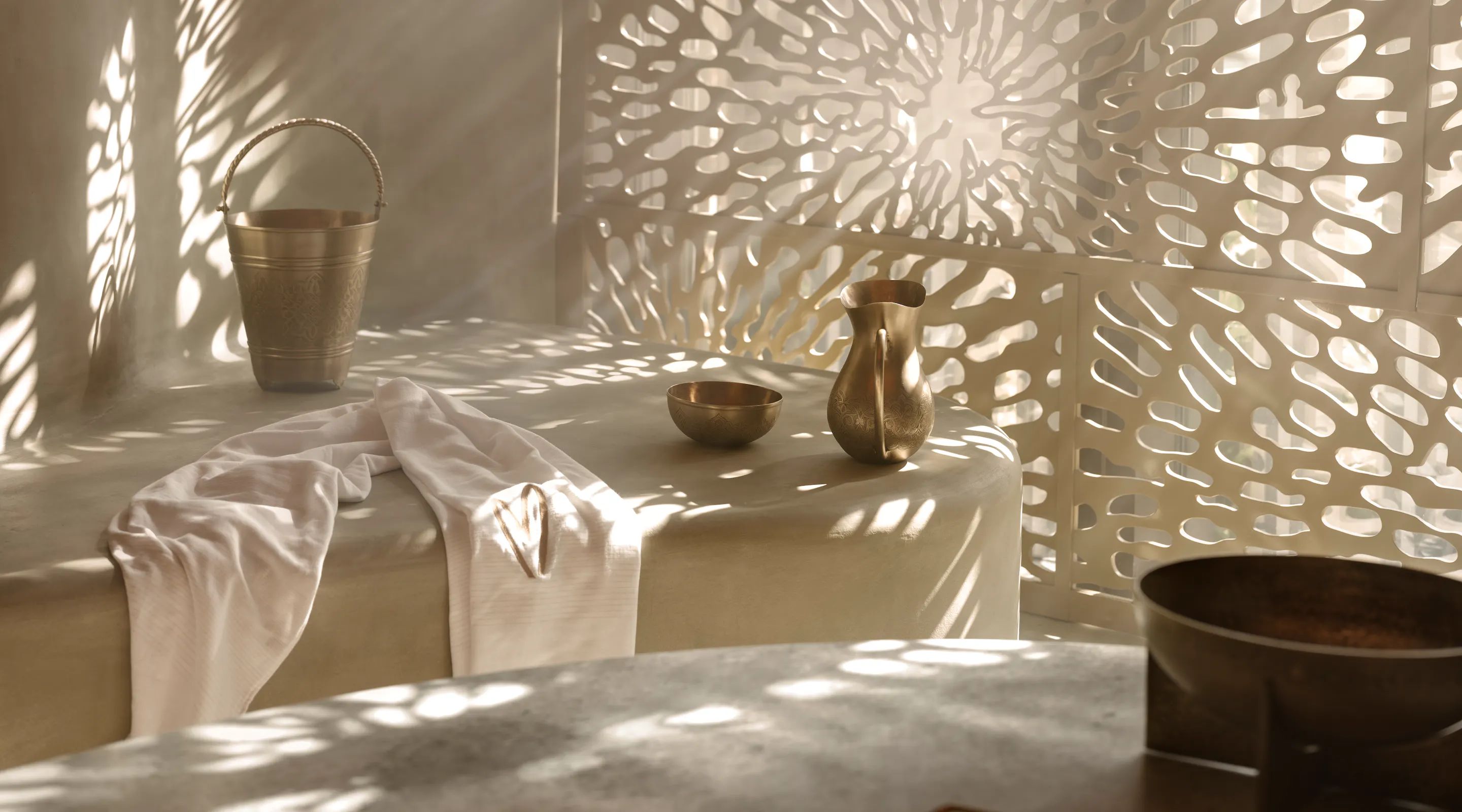 Hammam basin with traditional bathing tools at Meraki Wellness