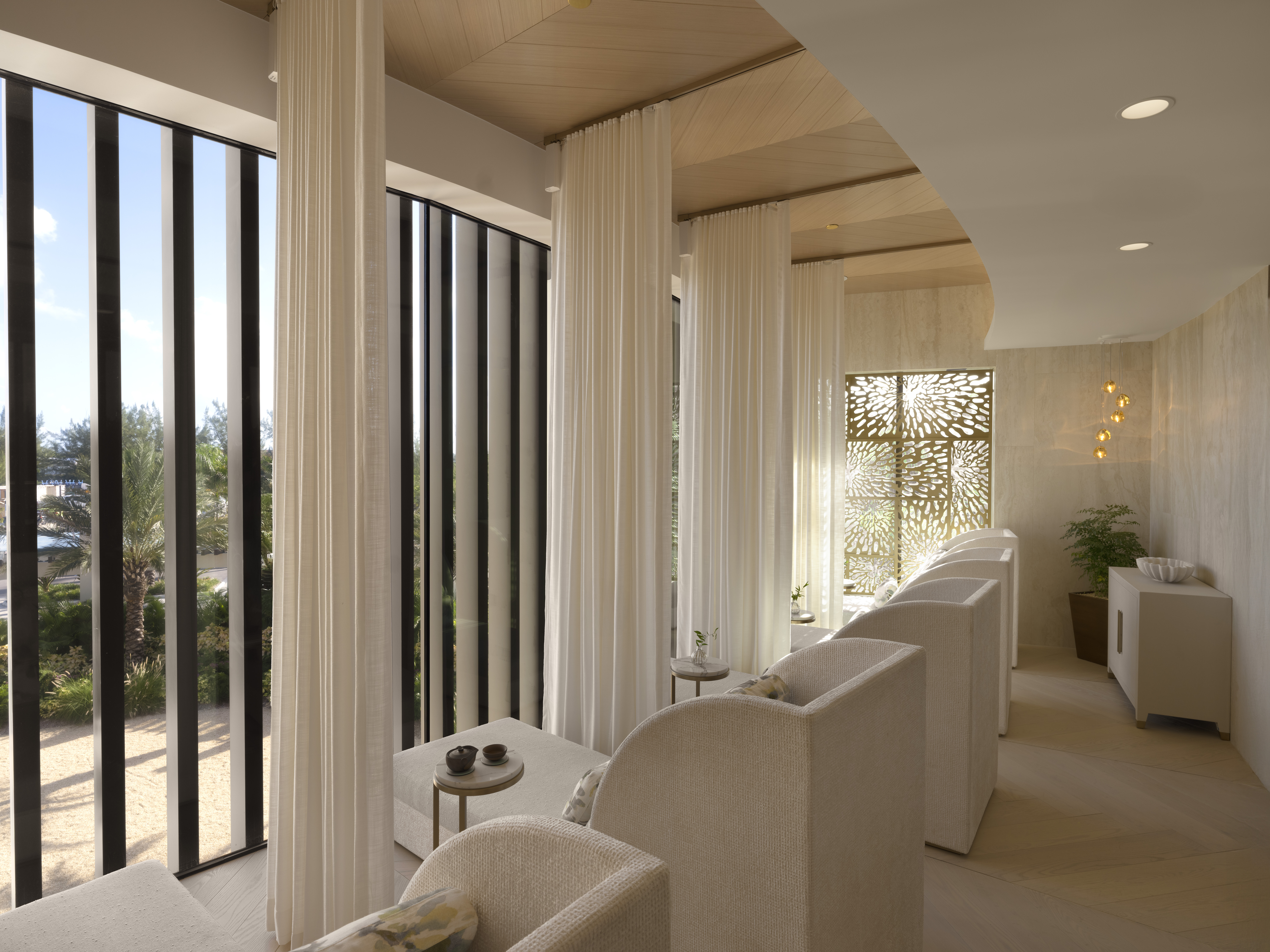 Quiet Lounge with relaxation day beds and floor to ceiling windows at Meraki Wellness