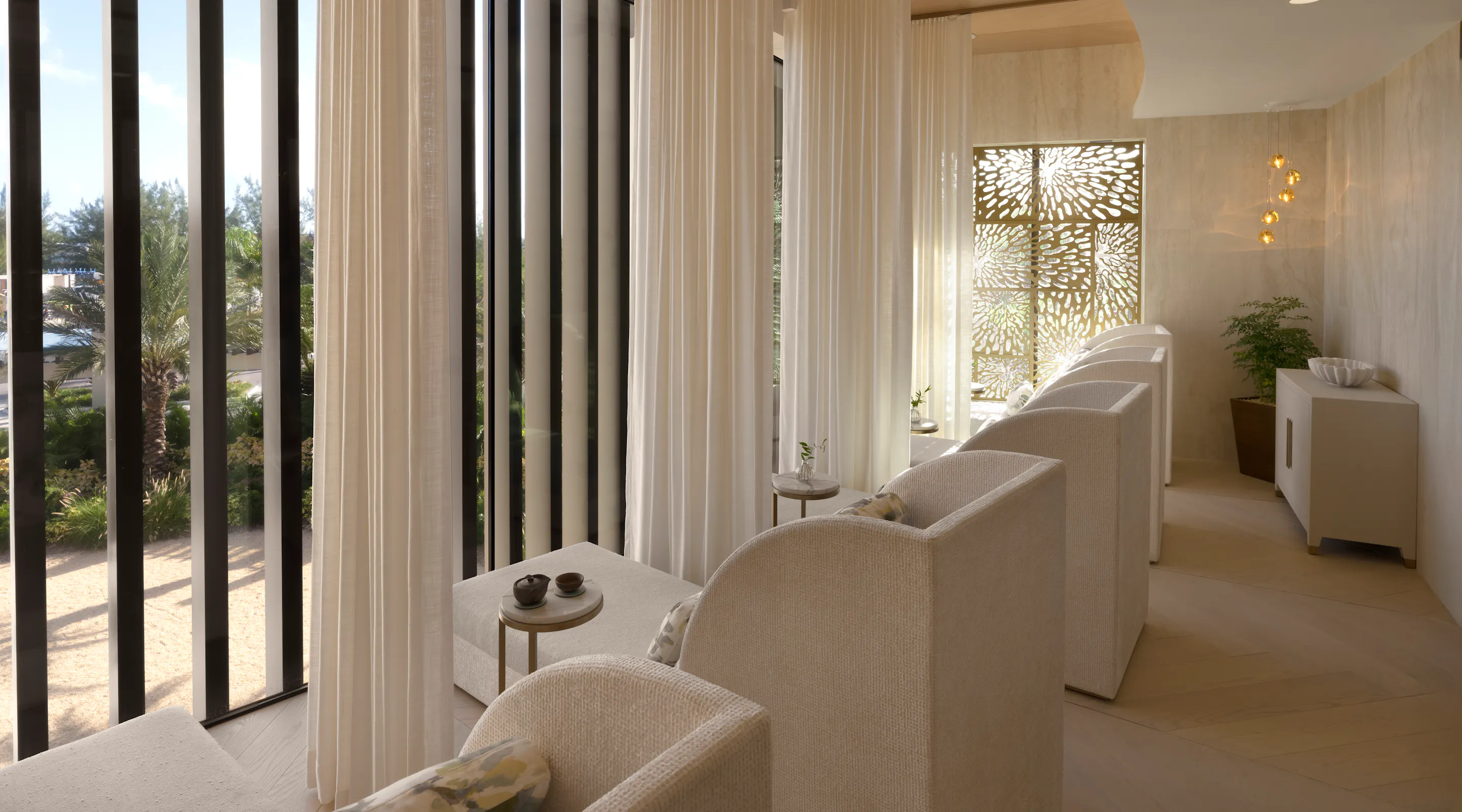 Quiet Lounge with relaxation day beds and floor to ceiling windows at Meraki Wellness